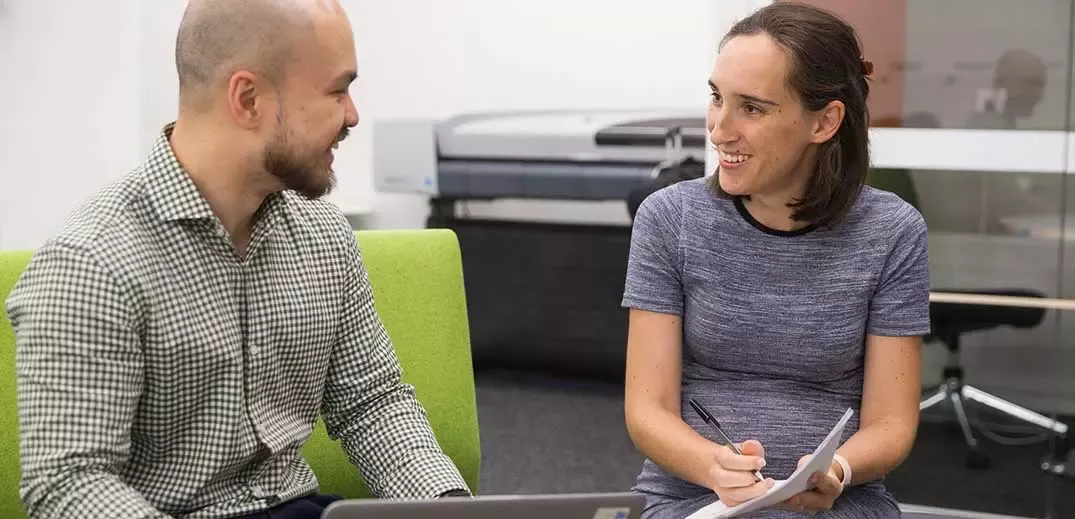 man-woman-office-discussion-wide